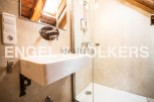 Charming bathroom with modern fixtures and a spacious shower stall.