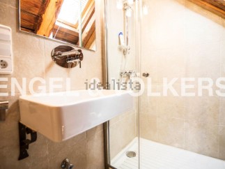 Charming bathroom with modern fixtures and a spacious shower stall.