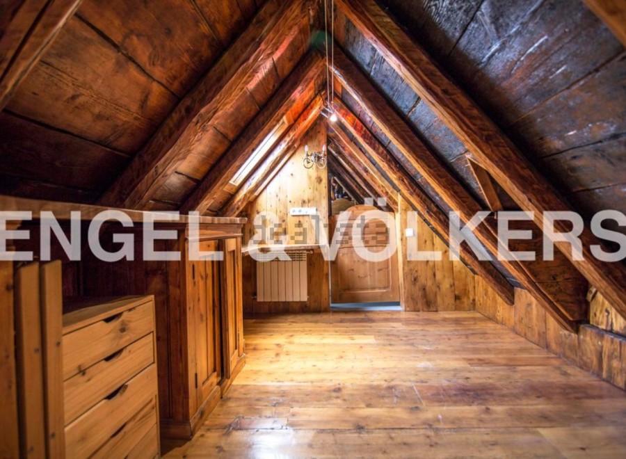 Discover this unique attic space with exposed wooden beams and charming wooden floors.