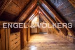Discover this unique attic space with exposed wooden beams and charming wooden floors.
