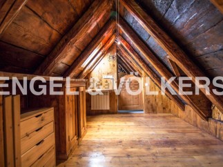 Discover this unique attic space with exposed wooden beams and charming wooden floors.