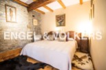 Cosy bedroom with stone walls and wooden beams, offering a rustic charm.