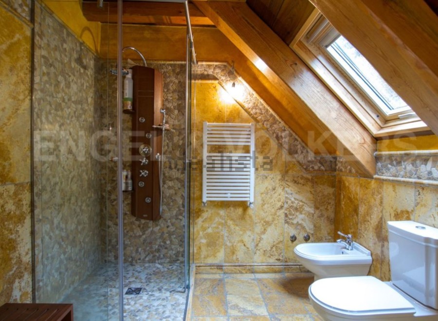 Luxury bathroom with a walk-in shower, bidet, and toilet.