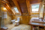 Luxury bathroom with wooden beams and skylights.