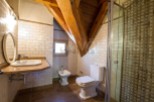 Charming bathroom with rustic wooden beams and tiled walls.