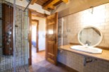 This stunning bathroom boasts a spacious shower with multiple shower heads and a modern, sleek design.