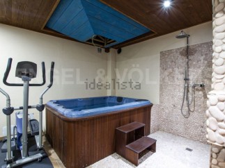 This luxurious property boasts a stunning indoor spa area, complete with a jacuzzi and a pebble-tiled shower.