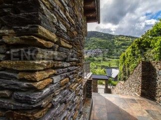 This stunning property boasts a unique stone exterior, perfectly complementing the picturesque mountain views.
