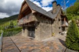 Mountain retreat with stone exterior and wooden accents.