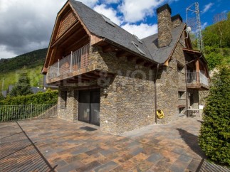 Mountain retreat with stone exterior and wooden accents.