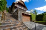 Mountain retreat with stone and wood exterior, offering stunning views.