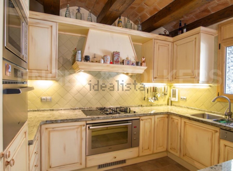 Rustic kitchen with granite countertops and wooden cabinets.
