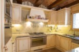 Rustic kitchen with granite countertops and wooden cabinets.