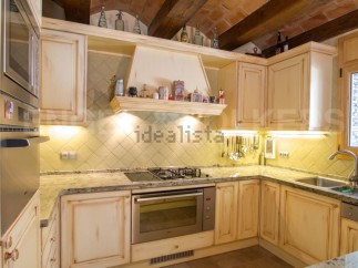 Rustic kitchen with granite countertops and wooden cabinets.