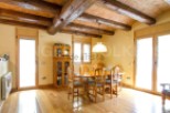 This stunning property boasts a spacious dining area with a rustic wooden table and chairs, perfect for family gatherings.