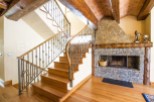 This stunning property boasts a grand wooden staircase with an intricate metal railing, adding elegance to the home.