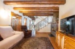 This stunning property boasts a spacious living area with exposed wooden beams, creating a warm and inviting atmosphere.