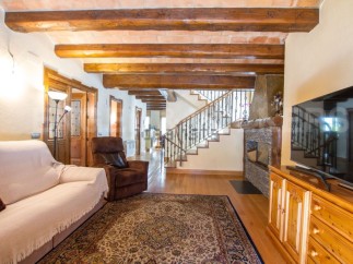 This stunning property boasts a spacious living area with exposed wooden beams, creating a warm and inviting atmosphere.