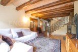 This stunning property boasts a spacious living area with exposed wooden beams and a cozy atmosphere.