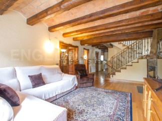 This stunning property boasts a spacious living area with exposed wooden beams and a cozy atmosphere.