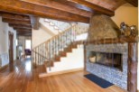 This stunning property boasts a beautiful wooden staircase with wrought iron railings, leading to an upper level.