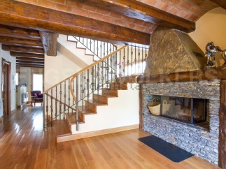 This stunning property boasts a beautiful wooden staircase with wrought iron railings, leading to an upper level.