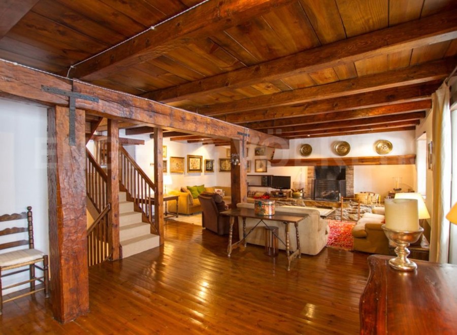 This stunning property boasts a spacious living area with exposed wooden beams and a beautiful wooden floor.