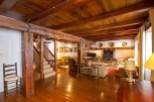 This stunning property boasts a spacious living area with exposed wooden beams and a beautiful wooden floor.