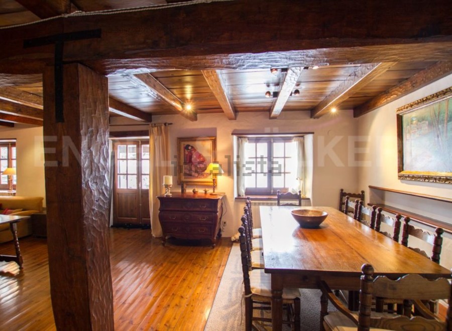 This stunning property boasts a spacious dining area with a large wooden table perfect for family gatherings.