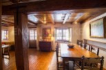 This stunning property boasts a spacious dining area with a large wooden table perfect for family gatherings.