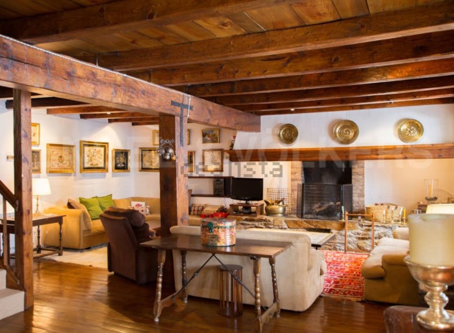 Rustic charm meets modern comfort in this stunning home boasting exposed wooden beams, a cozy fireplace, and ample living space.