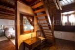 Charming rustic home with exposed wooden beams and a cozy wooden staircase.