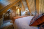 Cosy attic bedroom with wooden beams and stylish decor.