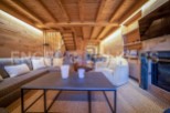 This stunning chalet boasts a spacious living area with a cozy fireplace, perfect for relaxing after a day on the slopes.