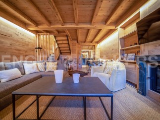 This stunning chalet boasts a spacious living area with a cozy fireplace, perfect for relaxing after a day on the slopes.