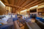 This stunning chalet boasts a spacious open-plan living area with a cozy fireplace, perfect for relaxing after a day on the slopes.