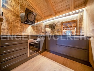 This stunning kitchen boasts a unique blend of rustic charm and modern elegance.
