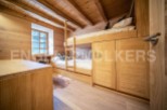 Charming wooden bunk beds with built-in storage create a cozy and functional space.