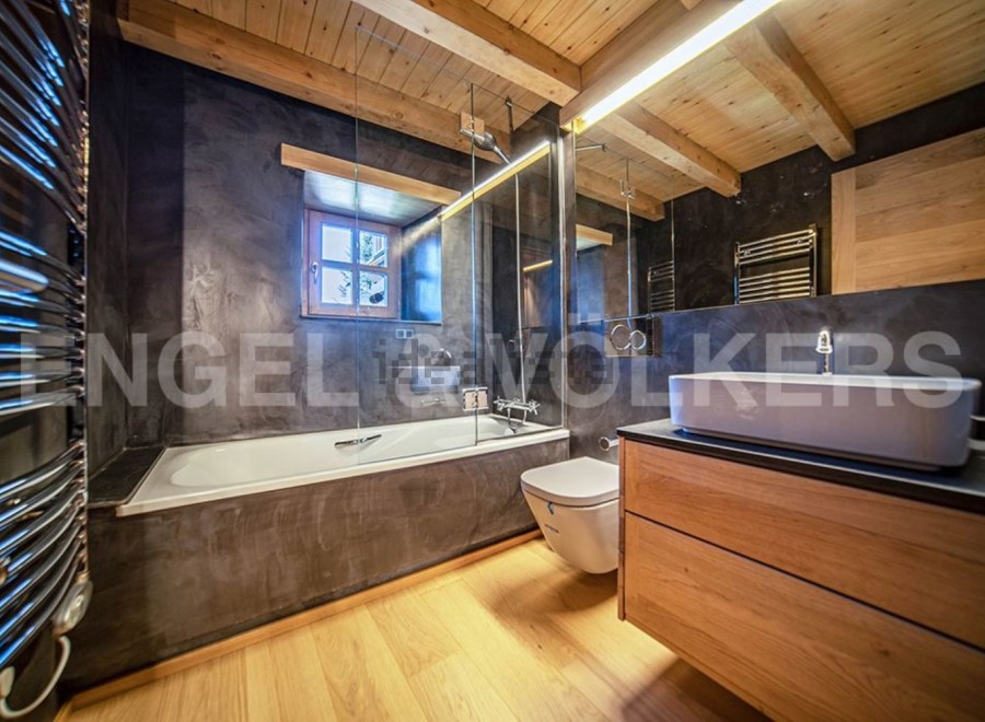 This stunning bathroom boasts a sleek, modern design with a freestanding bathtub and a spacious vanity.