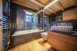 This stunning bathroom boasts a sleek, modern design with a freestanding bathtub and a spacious vanity.