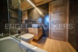 This stunning bathroom boasts a sleek, modern design with high-end finishes.