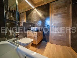 This stunning bathroom boasts a sleek, modern design with high-end finishes.