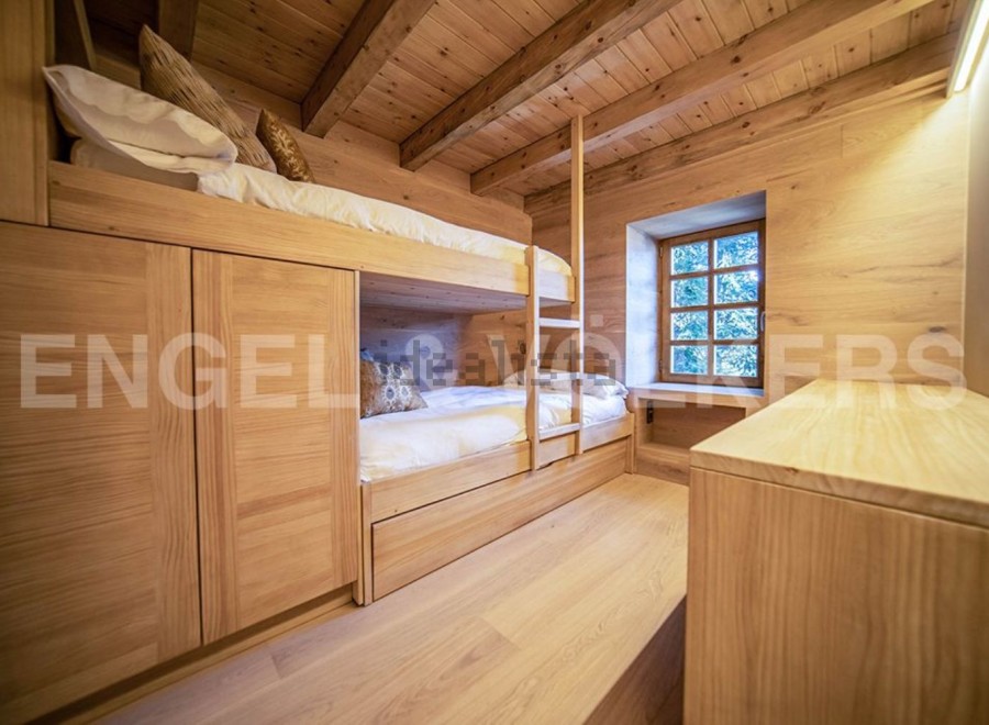 Charming wooden bunk beds built into the wall, maximizing space in this cozy chalet bedroom.