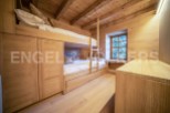 Charming wooden bunk beds built into the wall, maximizing space in this cozy chalet bedroom.
