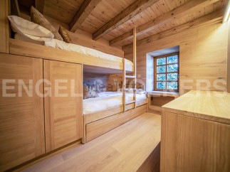 Charming wooden bunk beds built into the wall, maximizing space in this cozy chalet bedroom.