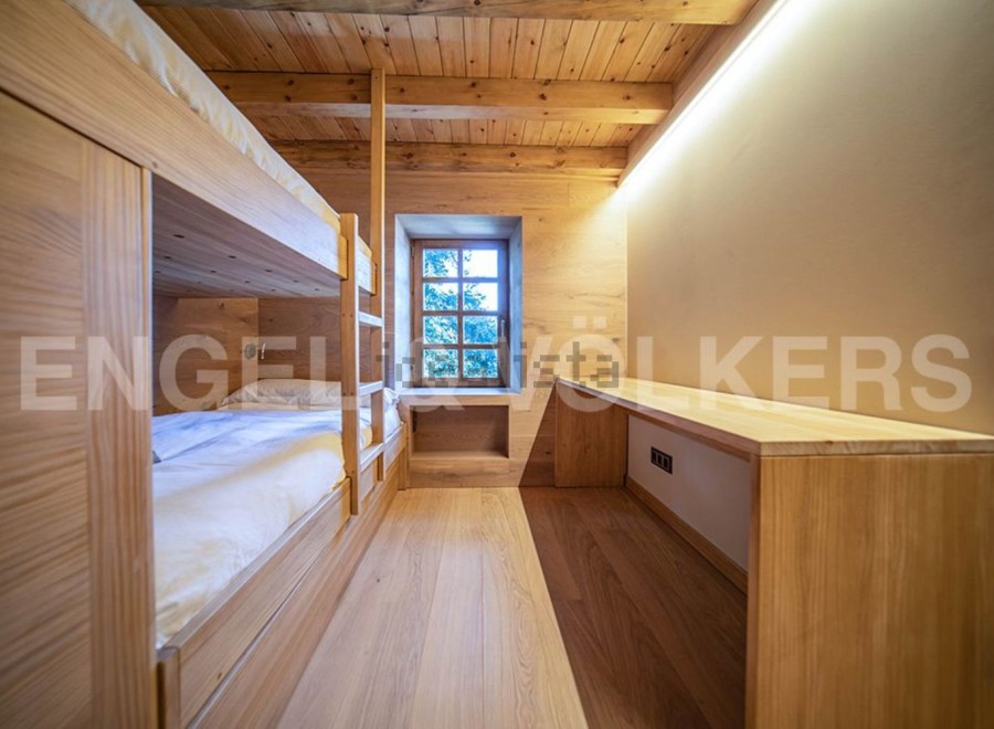 Cozy wooden bunk beds in a charming chalet-style room.