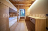 Cozy wooden bunk beds in a charming chalet-style room.