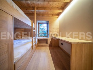 Cozy wooden bunk beds in a charming chalet-style room.
