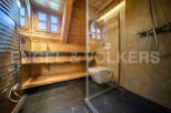 This stunning bathroom boasts a unique blend of rustic charm and modern amenities.