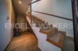 This stunning property boasts a beautiful tiled staircase with wooden accents, adding a touch of elegance to the home.